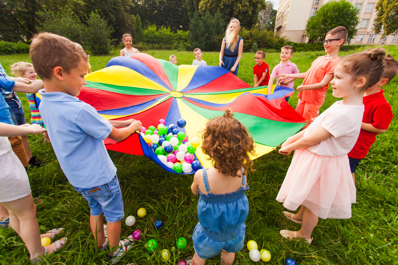 Cheerful Children Playing Outdoors at Birthday Party