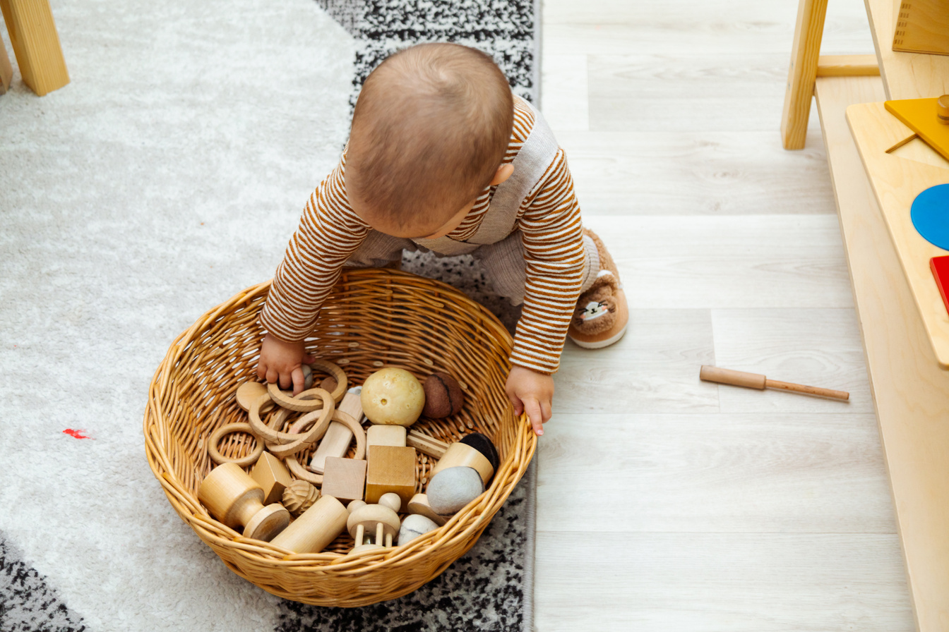 Toddler playing with montessori toys
